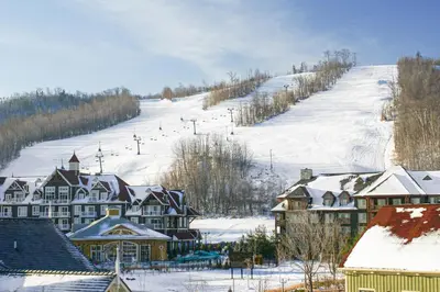 a town with a snow covered hill with a ski slope at Condo 713 at North Creek Resort in Blue Mountains