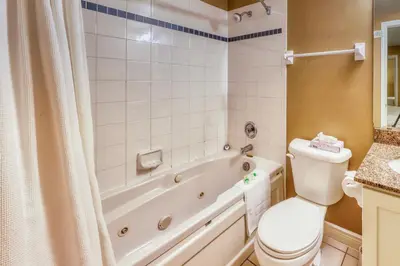 a bathroom with a tub and a toilet and a sink at Condo 903 at North Creek Resort in Blue Mountains