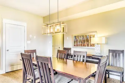 a dining room with a wooden table and chairs at Rivergrass 226 in Blue Mountains