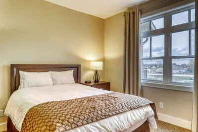 a bedroom with a bed and a large window at Rivergrass 226 in Blue Mountains