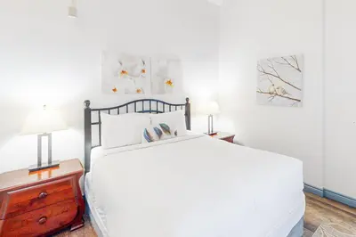 a bedroom with a large white bed and two lamps at Condo 416 at North Creek Resort in Blue Mountains