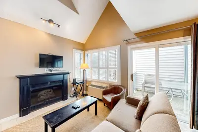 a living room with a couch and a fireplace at Condo 710 at North Creek Resort in Blue Mountains