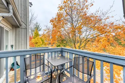 a patio with a table and chairs on a balcony at Condo 214 at North Creek Resort by Vacasa II in Blue Mountains