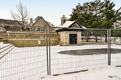 a fence in front of a house in the snow at Condo 214 at North Creek Resort by Vacasa II in Blue Mountains