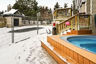 a hot tub in the snow next to a fence at Condo 212 at North Creek Resort by Vacasa in Blue Mountains