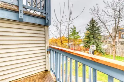 a house with a blue railing on a balcony at Condo 212 at North Creek Resort by Vacasa in Blue Mountains