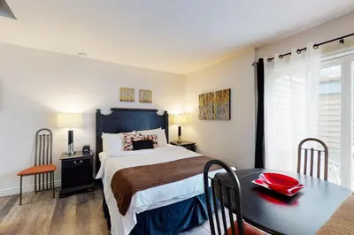 a bedroom with a large bed and a table at Condo 212 at North Creek Resort by Vacasa in Blue Mountains