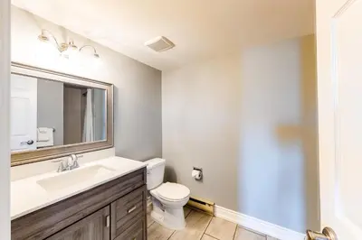 a bathroom with a sink and a toilet and a mirror at Wintergreen 223 in Blue Mountains
