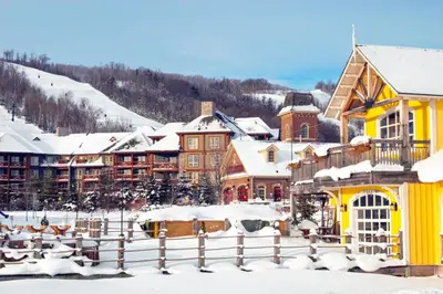 a resort in the snow with snow covered buildings at Condo 807 at North Creek Resort in Blue Mountains