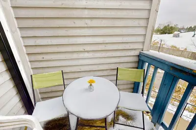 a white table and chairs on a balcony at Condo 816 at North Creek Resort in Blue Mountains