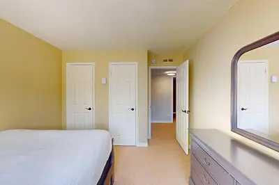 a bedroom with a white bed and a mirror at Wintergreen 218 in Blue Mountains
