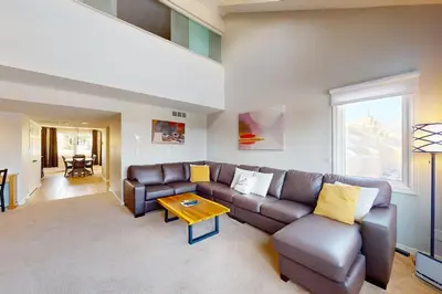 a living room with a couch and a table at Wintergreen 218 in Blue Mountains
