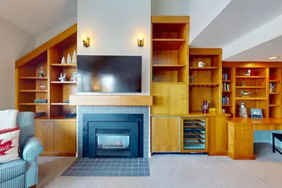 a living room with a fireplace and a flat screen tv at Wintergreen 218 in Blue Mountains