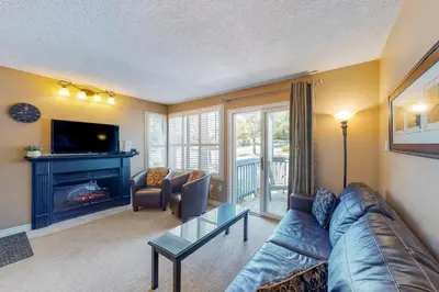 a living room with a couch and a fireplace at Condo 505 at North Creek Resort in Blue Mountains
