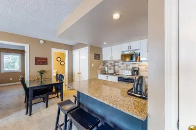 a kitchen with a counter and a dining room at Condo 505 at North Creek Resort in Blue Mountains