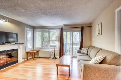 a living room with a couch and a fireplace at Condo 305 at North Creek Resort in Blue Mountains