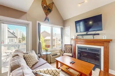 a living room with a couch and a fireplace at Condo 614 at North Creek Resort in Blue Mountains