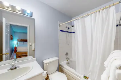 a bathroom with a toilet and a sink and a bath tub at Condo 110 at North Creek Resort in Blue Mountains