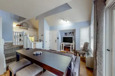 a dining room with a table and chairs and a kitchen at Condo 110 at North Creek Resort in Blue Mountains