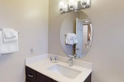 a bathroom with a sink and a mirror at Wintergreen 202 in Blue Mountains