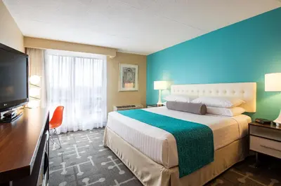 a hotel room with a large bed and a flat screen tv at Howard Johnson Plaza by Wyndham by the Falls Niagara Falls in Niagara Falls