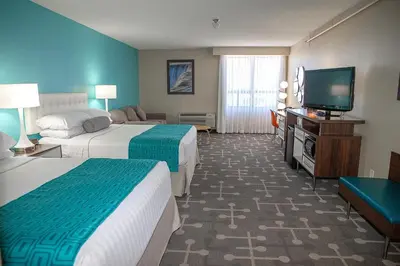 a hotel room with two beds and a flat screen tv at Howard Johnson Plaza by Wyndham by the Falls Niagara Falls in Niagara Falls