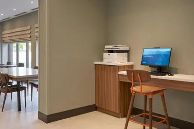 a room with a desk with a computer on it at Fairfield by Marriott Niagara Falls, Canada in Niagara Falls