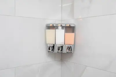 a mirror in a bathroom with white tiles at Mountainside Resort Condo at Blue in Blue Mountains