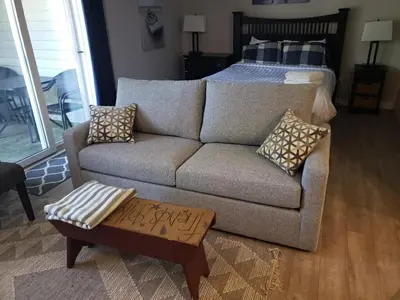 a living room with a couch and a bed at Mountainside Resort Condo at Blue in Blue Mountains