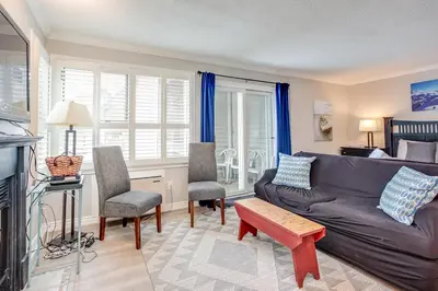 a living room with a couch and a table and chairs at Mountainside Resort Condo at Blue in Blue Mountains