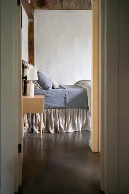 a bedroom with a bed and a table with a lamp at Owl's Nest Suites in Carrying Place