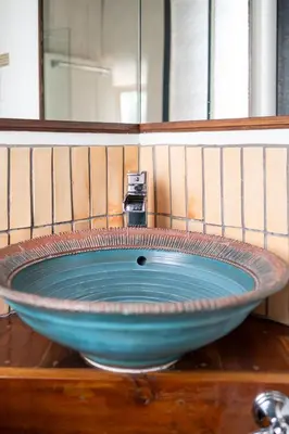 a bowl sink with a faucet in a bathroom at Owl's Nest Suites in Carrying Place