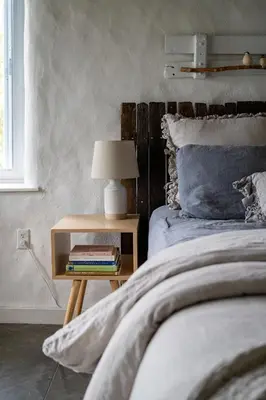 a bedroom with a bed and a table with a lamp at Owl's Nest Suites in Carrying Place