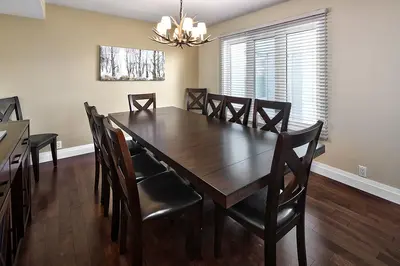 a dining room with a wooden table and chairs at Large luxurious upper floor condo in Sierra Lane in Blue Mountains