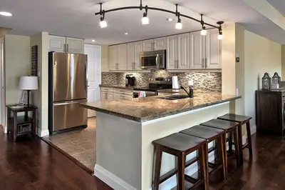 a kitchen with a large island with bar stools at Large luxurious upper floor condo in Sierra Lane in Blue Mountains