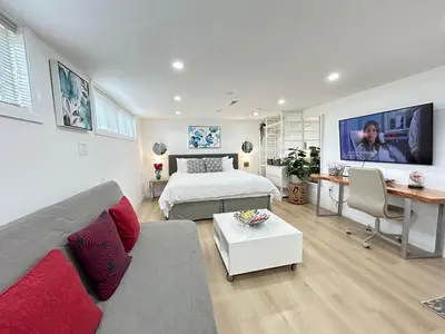 a bedroom with a bed and a desk in a room at Modern Lux Family Rooms - KingBed - Near Sheppard W Station Toronto in Toronto