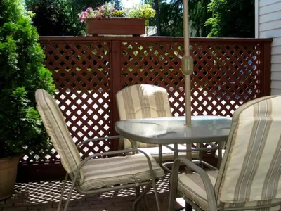 a patio with a table and chairs and an umbrella at Canterbury Inn in Niagara on the Lake