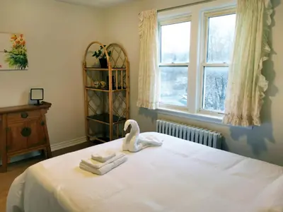a bedroom with a bed with towels and a swan on it at Cozy Private Rm Heart of North York Free Parking Full Kitchen Close to Downtown in Toronto