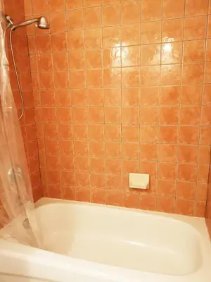 a bath tub in a bathroom with orange tile at Cozy Private Rm Heart of North York Free Parking Full Kitchen Close to Downtown in Toronto
