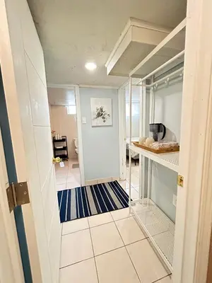 a room with a hallway with a kitchen and a room with at Cozy basement room-Private Bath - Near Subway line 1 - Toronto in Toronto