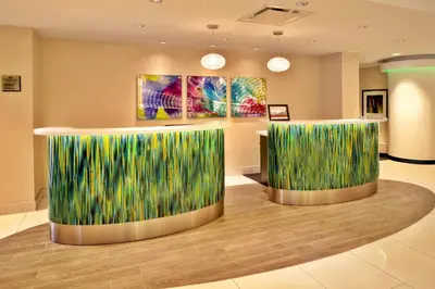 a lobby with two reception desks with green grass at Crowne Plaza Kitchener-Waterloo by IHG in Kitchener
