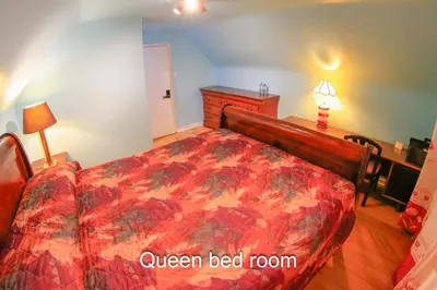 a bedroom with a bed with a red comforter at Comfort Home Toronto in Toronto