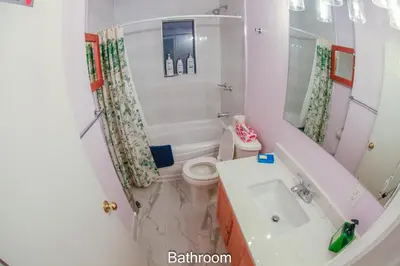 a bathroom with a toilet and a tub and a sink at Comfort Home Toronto in Toronto