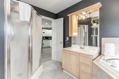 a bathroom with a shower and a sink at Beach1 Riverfront Resort in Wasaga Beach