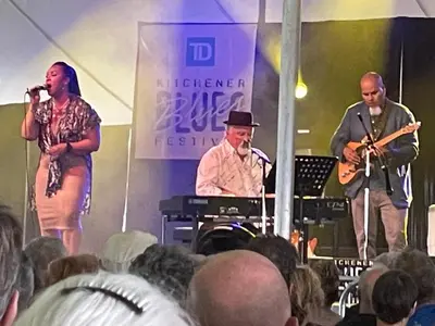 a group of three men on a stage playing music at Hammer Haus II in Waterloo