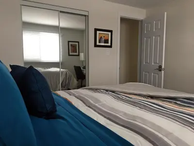 a bedroom with a bed and a large mirror at Hammer Haus II in Waterloo