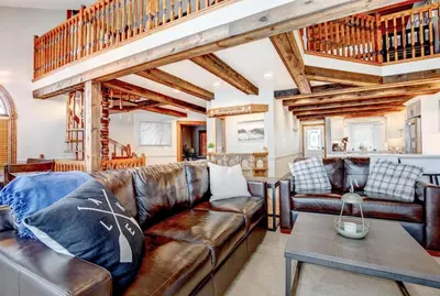 a living room with a leather couch and a table at Kawartha Lakes, Fenelon Falls in Fenelon Falls