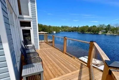 a deck on a house with a view of the water at Kawartha Lakes, Fenelon Falls in Fenelon Falls