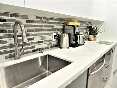 a kitchen counter with a sink and a coffee maker at iResidence in Toronto - Fantastic Vacation Home with Breakfast in Toronto