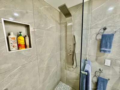 a bathroom with a shower stall with blue towels at iResidence in Toronto - Fantastic Vacation Home with Breakfast in Toronto